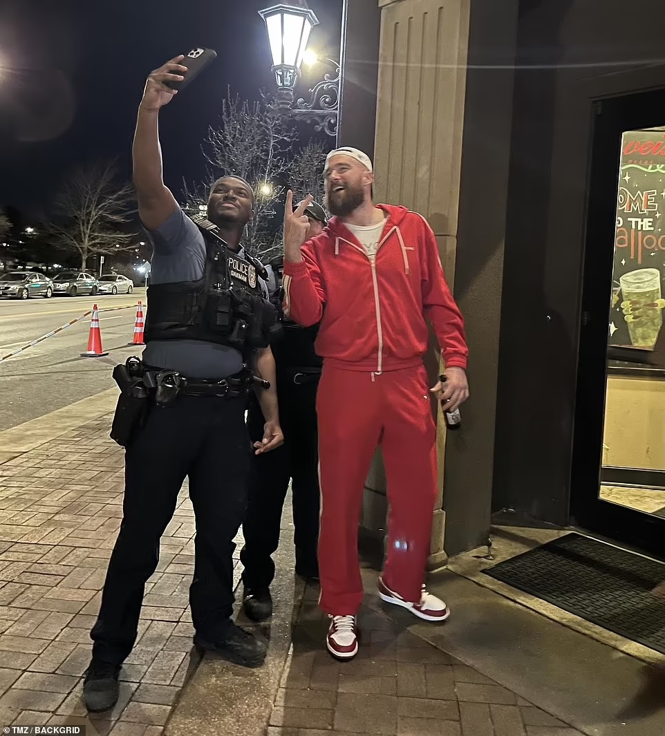 Travis Kelce pose for picture after shooting