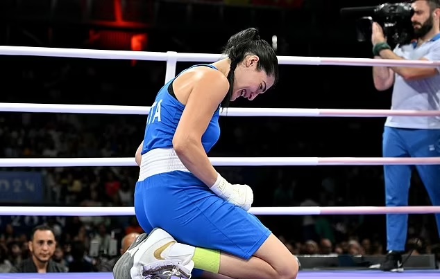 The Italian boxer dropped to her knees after abandoning and was seen crying in the ring