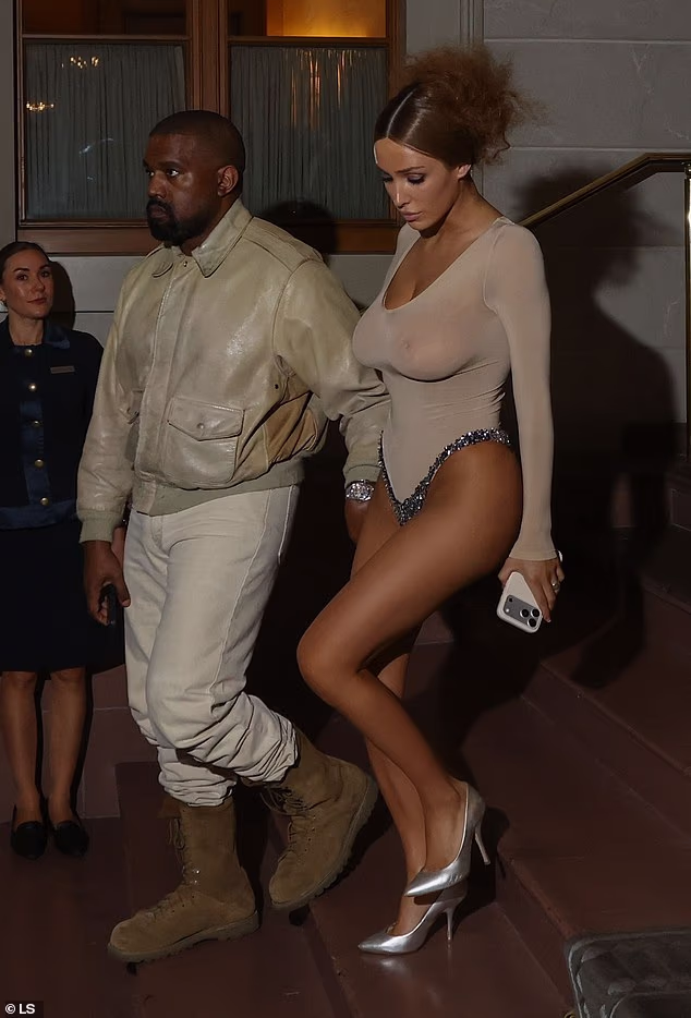 Kanye West’s wife Bianca Censori shocks once again as she goes braless in a sheer thong leotard as the couple step out in Switzerland...