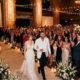 First Glimpse of the Moment Travis Kelce and Taylor Swift Stun in Pure White as They Walk Into MSG Hall for Their Wedding Rehearsal Dinner and Receive a Standing Ovation from Family, Friends, and A-List Celebrities… See Never-Before-Seen Photo